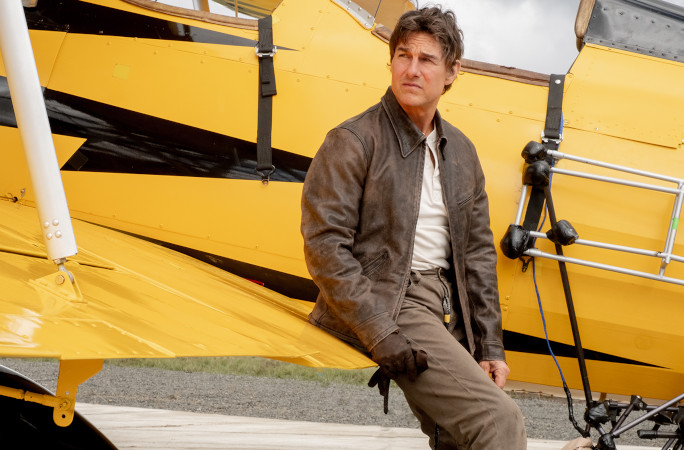 Tom posing next to a plane at the MI premiere