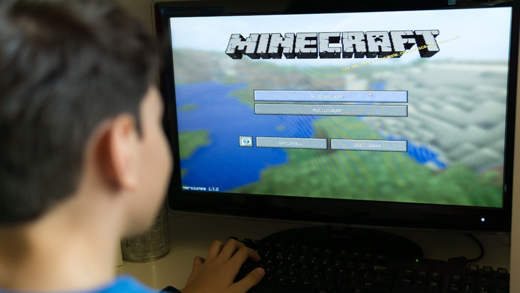 A young boy playing Minecraft