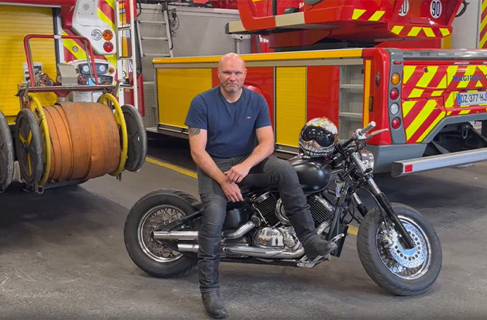 Jonathan on his bike at the fire station
