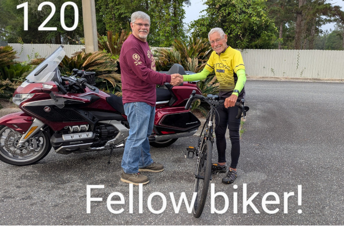 Bob giving a handshake to a fellow biker