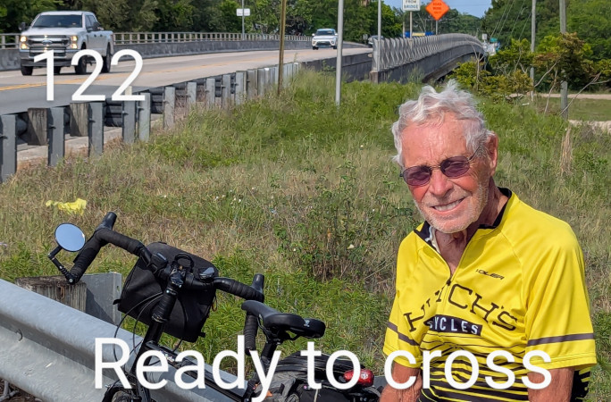 Bob smiling while crossing the street