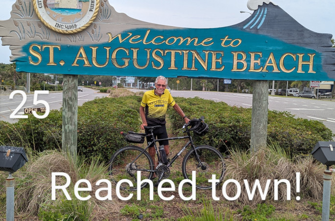 Bob with his bike under the St Augustine sign