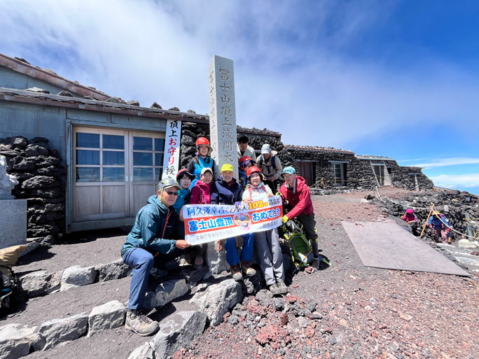 Kokichi at the summit with mountaineering club members