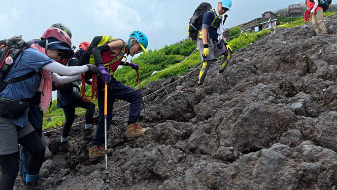 Kokichi climbing a rocky terrain