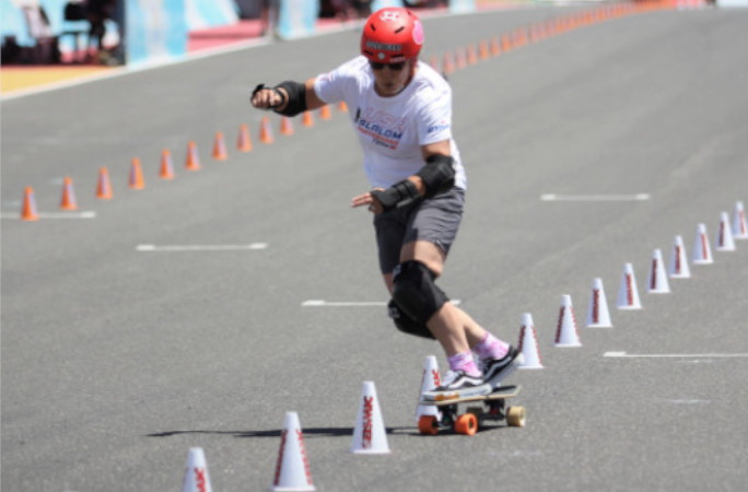 Judi weaving through cones on her skateboard