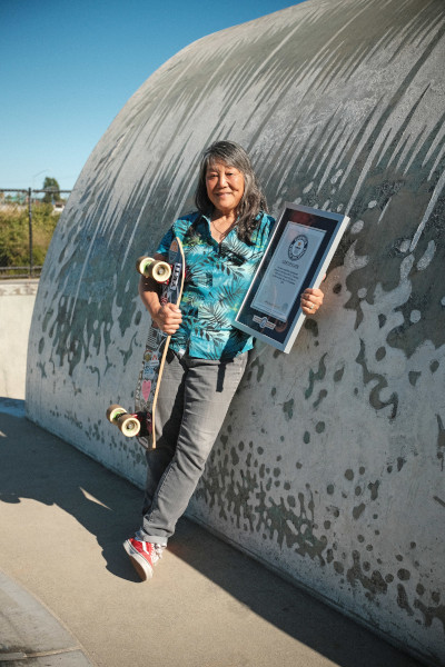 Judi holding her certificate by the wave ramp