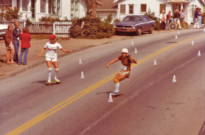 Judi racing a girl down a hill