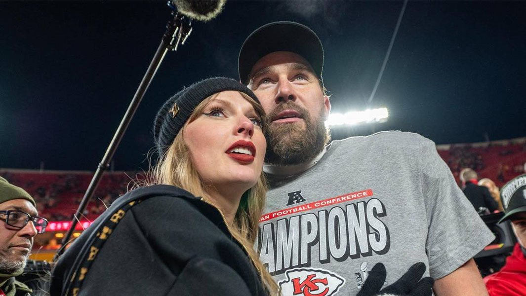 Taylor Swift and Travis Kelce hugging on the football field