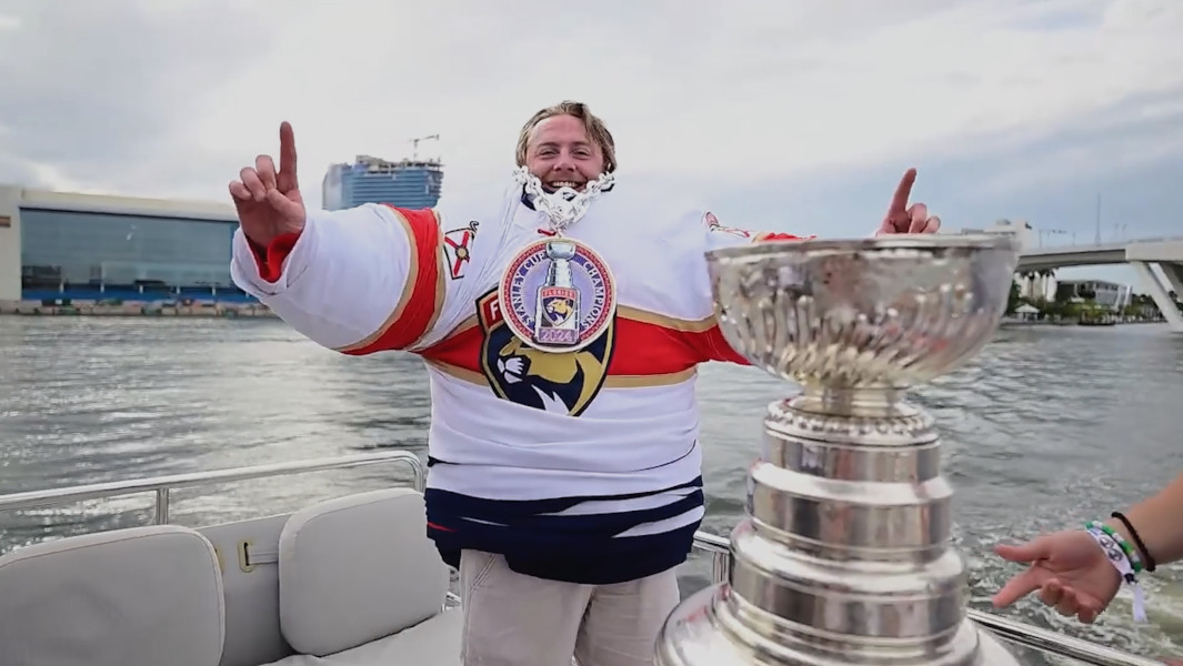 Dakota King with 40 jerseys on next to the Stanley Cup