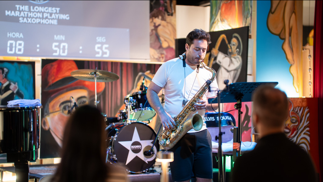 Elvis playing the saxophone in front of the audience