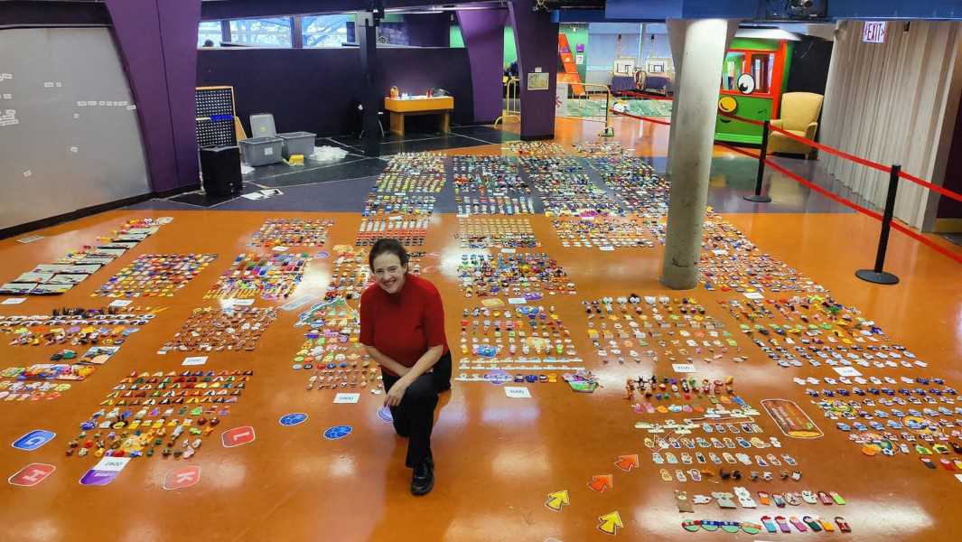 Cheralyn Lambeth smiling while next to her 3,000 finger puppets