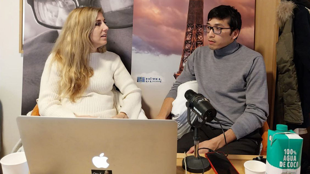 Steven and Chloe sitting at a desk during their interview