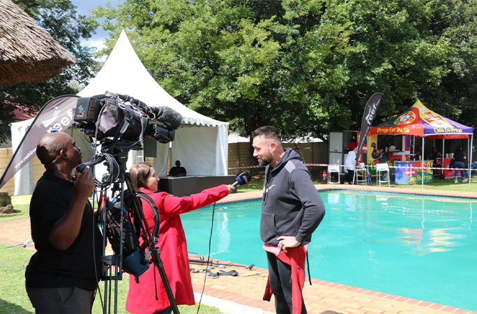 Andre being interviewed by the side of the pool