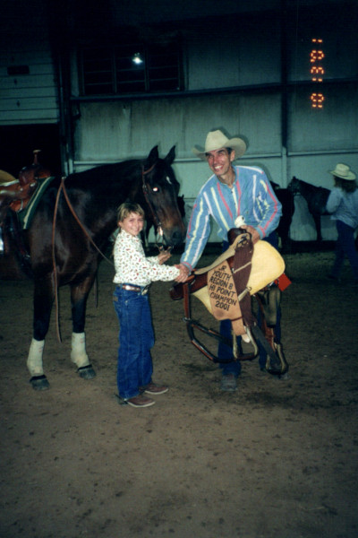 Paige accepting a riding award with Fancy as a kid