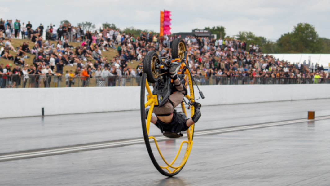Oscar upside down on motorcycle
