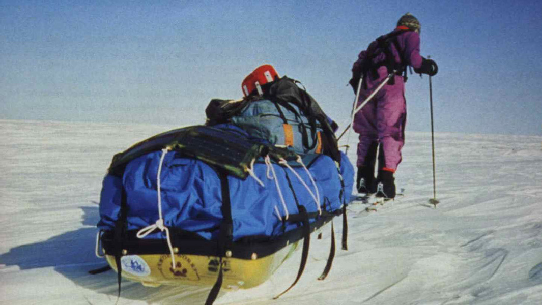 split image of Ann pulling a sled through the snow and making notes