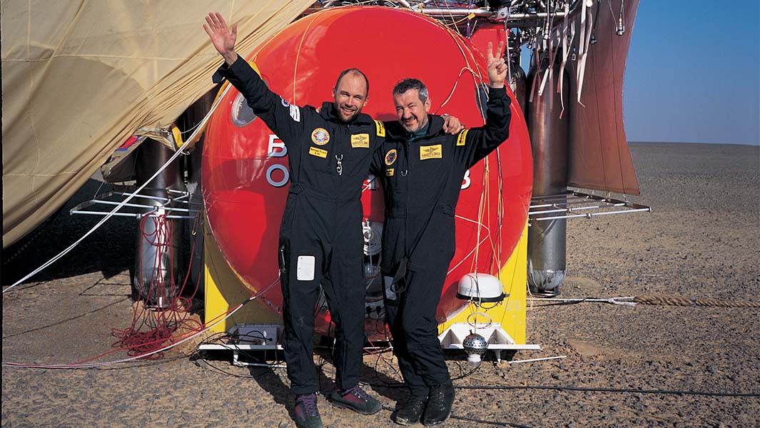 split image of Bertrand and Brian posing in front of their balloon and The Balloonists movie poster