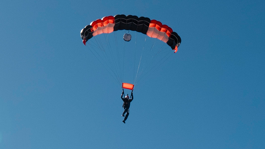 split image of highest skydive landing in the air and touching down
