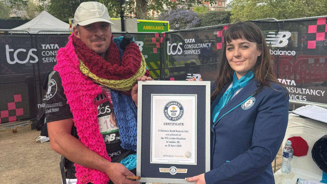 Split header of Simon holding his Guinness World Records certificate with a GWR Adjudicator