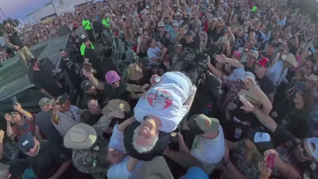Pauline smiling while being carried by the crowd