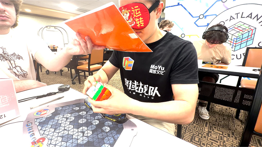 split image of Tommy solving a cube blindfolded and celebrating
