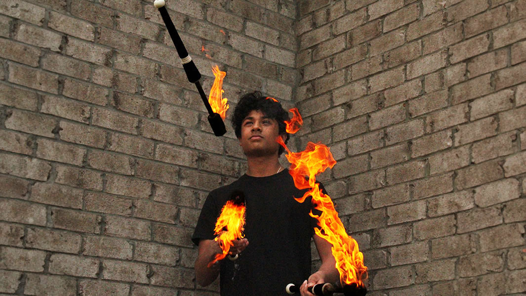 split image of Arnav juggling three flaming torches