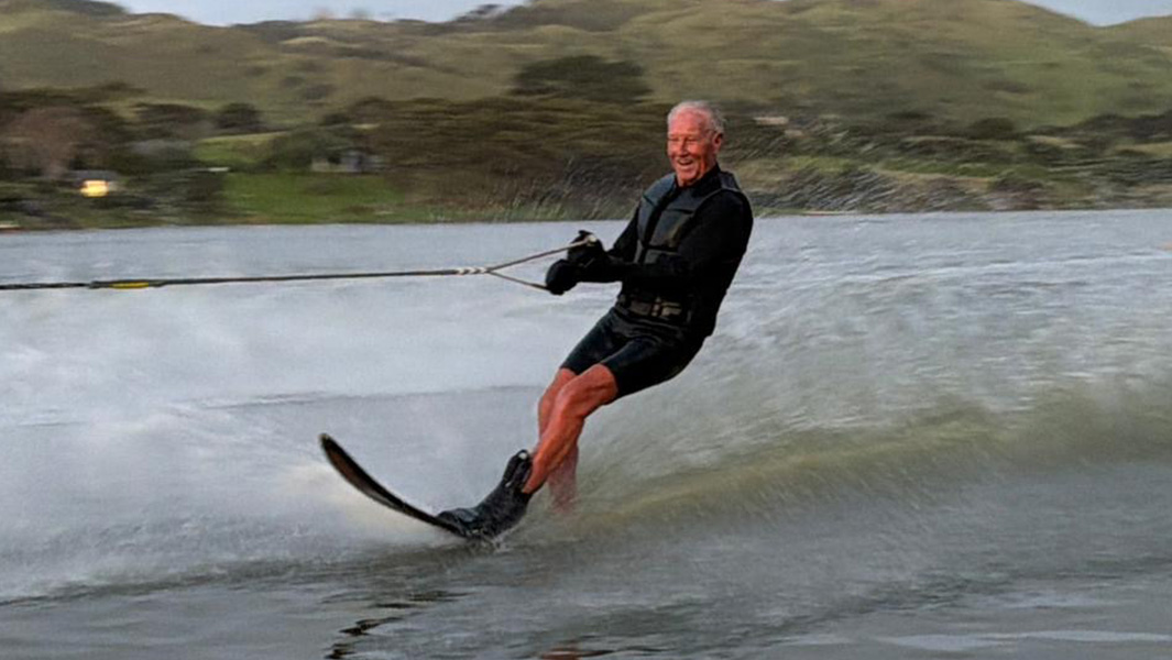 split image of Bryan heading to the water and waterskiing