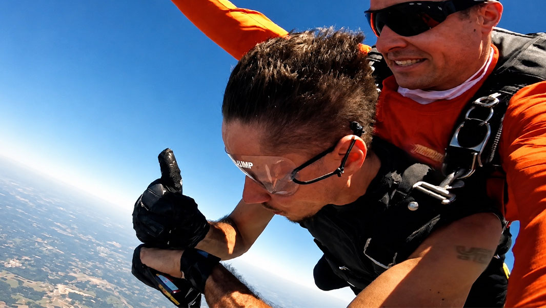 Funky Matas tattooing his own hand during a skydive