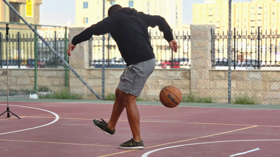 split image of Hamed holding a basketball and kicking one