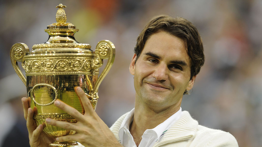 Roger Federer holding a Wimbledon trophy