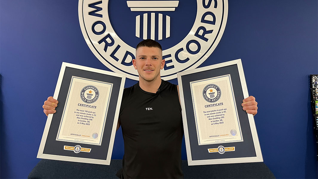 Alex holding two Guinness World Records certificates