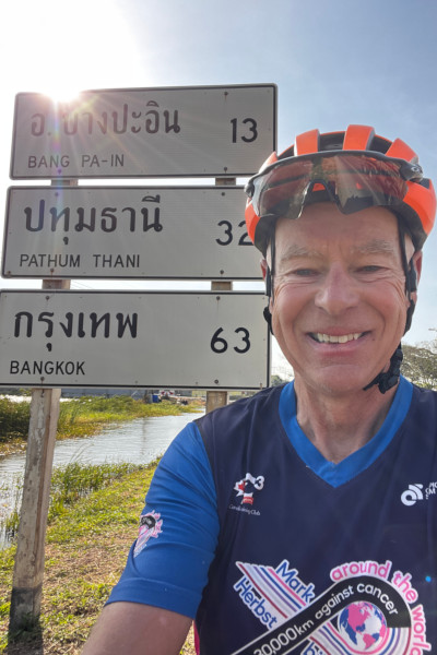 Mark taking a selfie with a Thai road sign
