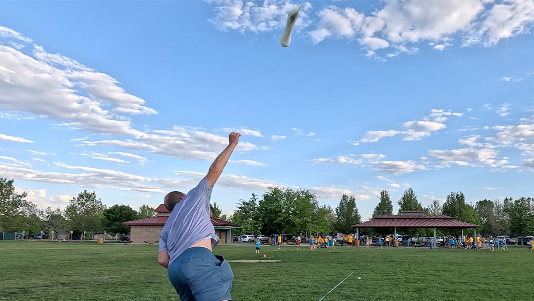 split image of David throwing the water balloon and Jeremy catching it