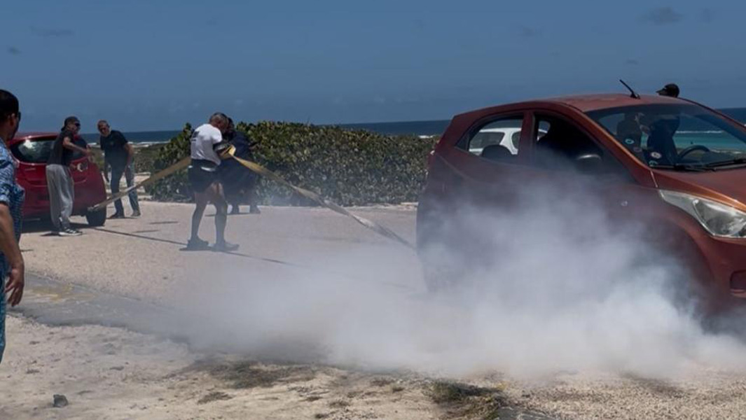 Egmond restraining two cars as they try to drive away