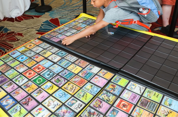 A person place a trading card in a binder