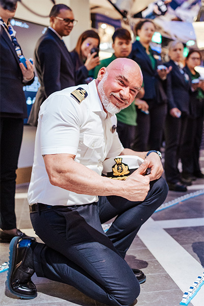 captain looking proud next to the line of ships