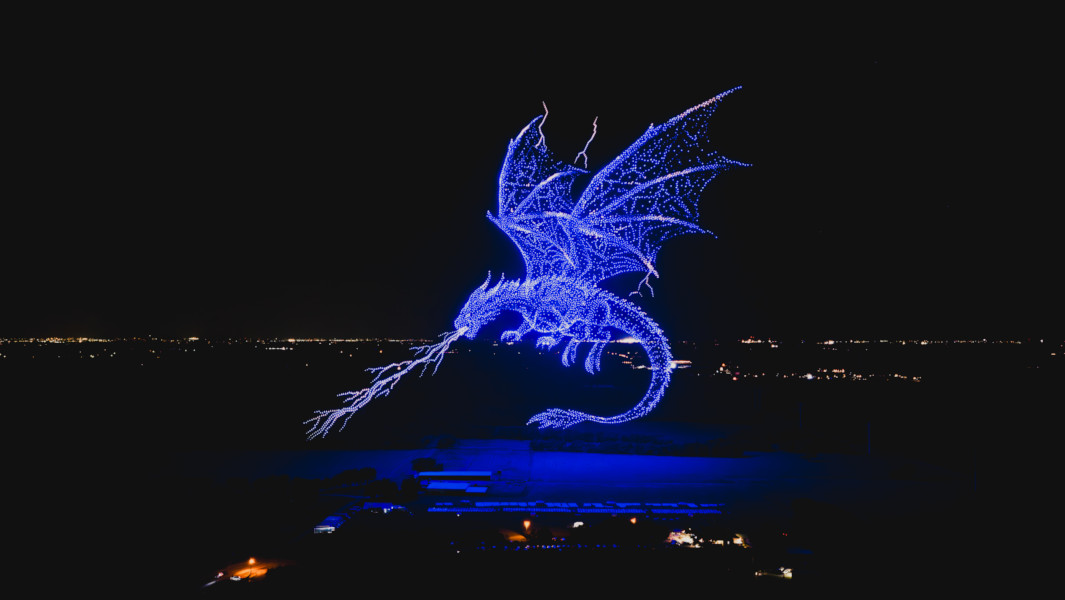 Split image of the drone dragon, and the organizers holding certificates next to the drones