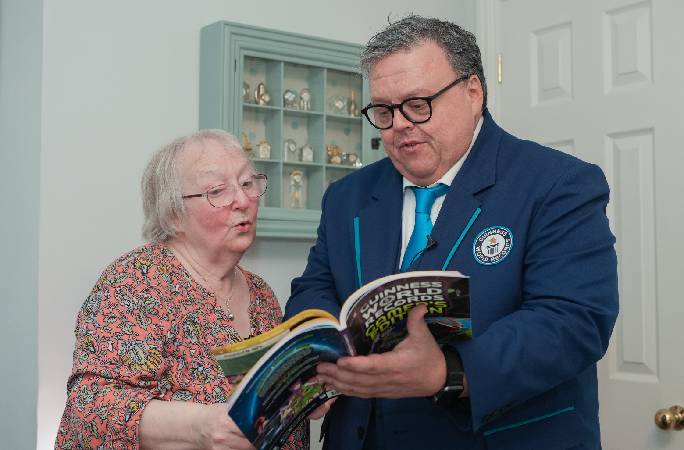 A split image of Cath Bowie, the oldest female Fornite streamer on Twitch. On the left she proudly holds up her World Record certificate along with a copy of the Gamer's Edition 2027, and on the right she holds her gamepad in front of her computer screen.