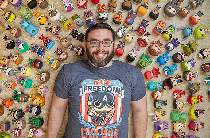 Paul lying down with his Funko Pop! collection