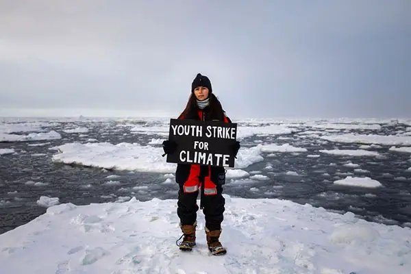 Mya-Rose holding a sign