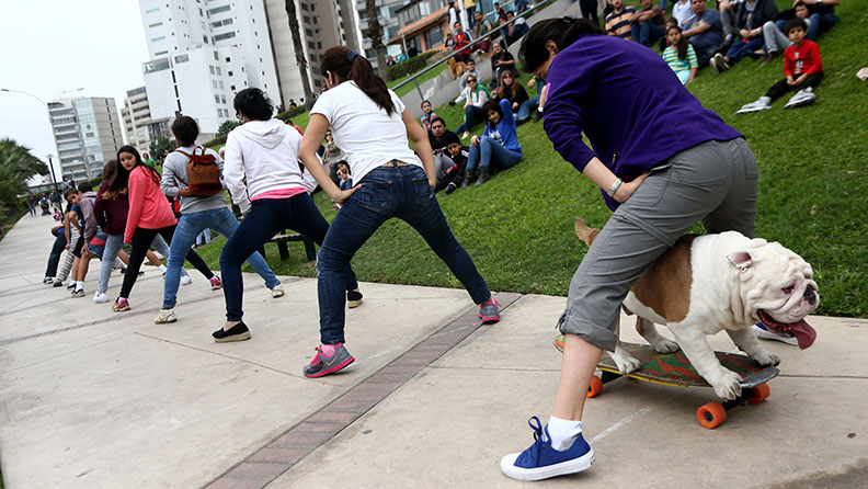 Otto skateboarding through peoples legs