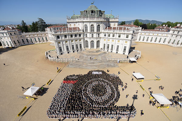 a group of people making a human image of a camera