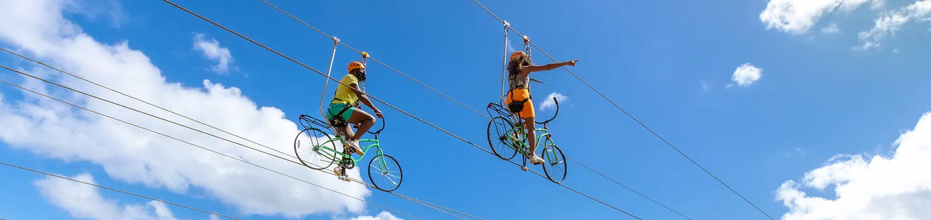 Man and Woman on a zip line with bicycles