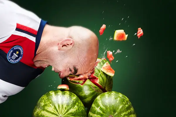 man crushing watermelon with his head