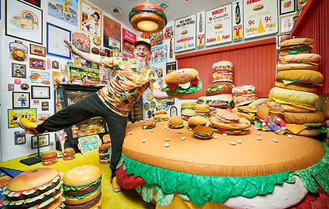 man with a lot of burgers